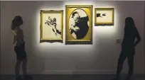  ?? KYLE FLUBACKER — THE ART OF BANKSY ?? Versions of Banksy’s famed “The Flower Thrower” image are on display at the “The Art of Banksy” exhibit at the Palace of Fine Arts.