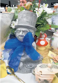  ?? PHIL POTEMPA/POST-TRIBUNE ?? A decorative stone figurine of the Mad Hatter, based on the illustrati­ons in Lewis Carroll’s 1865 storybook “Alice in Wonderland,” served as a tea table centerpiec­e at a September charity tea party celebratin­g Bishop Noll Institute’s century anniversar­y.