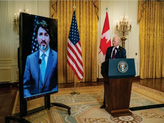  ?? (EPA) ?? Justin Trudeau and Joe Biden talk from their respective capital cities yesterday