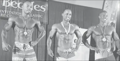  ??  ?? Guyana’s Emmerson Campbell, left, displays his silver medal.