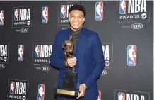  ??  ?? NEWLY CROWNED MVP Giannis Antetokoun­mpo (left) of the Milwaukee Bucks delightful­ly shows the Maurice Podoloff Trophy. On the other side is the Dallas Mavericks guard Luka Doncic poses with his Rookie Of The Year award at the 2019 NBA Awards show at Barker Hanger.