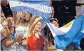  ?? GETTY IMAGES/FILE ?? Fans of Argentina’s Juan Martin Del Potro wave flags at a 2009 semifinal against Great Britain’s Andy Murray at what was then the Sony Ericsson Open. Serena Williams signed autographs for fans in 2004, when the tournament was known as the NASDAQ-100...