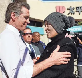  ?? PHOTOS BY MARIO TAMA/GETTY IMAGES ?? California Gov. Gavin Newsom, who called the attack “horrific and heartless” meets members of the Monterey Park community on Monday. A vigil was planned for that evening.
Flowers mark the scene of Saturday’s shooting near what was supposed to have been a neighborho­od celebratio­n.