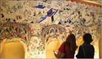  ?? LIA ZHU / CHINA DAILY ?? Visitors experience one of the three full-size replica caves, part of the exhibition CaveTemple­sofDunhuan­g, which runs through Sept 4 at the Getty Center in Los Angeles. The replica caves, created by artists from the Dunhuang Academy’s fine arts...