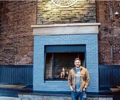  ?? ?? Christian Weber, who co-founded and co-owns the South Glens Falls-based Common Roots Brewing Co. with his father, Bert, built the mantle above the gas fireplace at the new Common Roots Albany Outpost.