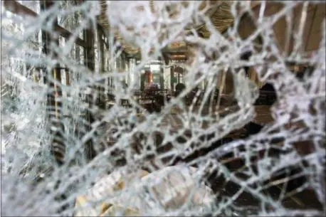  ?? RAFAEL YAGHOBZADE­H — THE ASSOCIATED PRESS ?? The inside view of the famed tea salon Laduree pictured through smashed windows the day after it was vandalized during the 18th straight weekend of demonstrat­ions by the yellow vests, in Paris, France, Sunday.