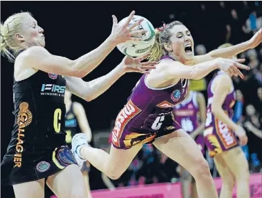  ?? Photo: PHOTOSPORT ?? Snatch and grab: The Magic’s Laura Langman grasps the ball ahead of Firebird Eliss Macleod.