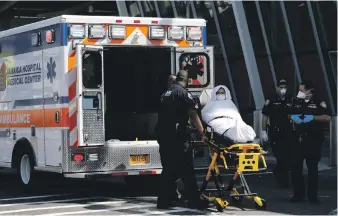  ?? EPA ?? A passenger from the Emirates flight from Dubai at JFK Internatio­nal Airport is taken to hospital for treatment for flu symptoms last Wednesday after passengers reported becoming unwell