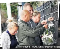  ??  ?? GRIEF-STRICKEN: Relatives visit the scene of the crash. Right, the mangled black Audi