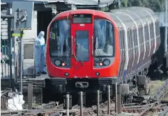  ?? FRANK AUGSTEIN / THE ASSOCIATED PRESS ?? A police officer inspects a London Tube train on Friday.