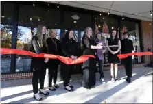  ?? BILL UHRICH - READING EAGLE ?? Heather Pasko, center, cuts the opening ribbon with her team on Nov. 3.