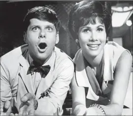  ?? Archive Photos Getty Images ?? ROBERT MORSE, left, and Michele Lee perform in a scene from the 1967 film adaptation of the stage hit “How to Succeed in Business Without Really Trying.”