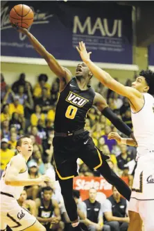  ?? Marco Garcia / Associated Press ?? Cal’s Justice Sueing (right) tries to defend VCU guard De’Riante Jenkins, who scored a game-high 27 points.