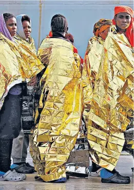  ??  ?? Migrants arrive in Augusta, Sicily, after being rescued by the Italian navy