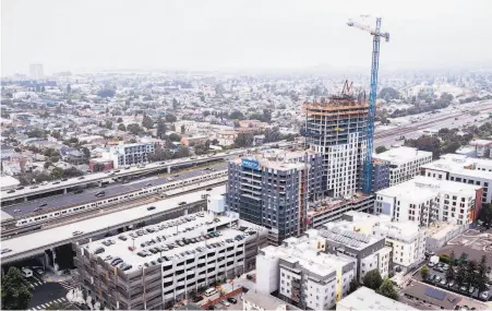  ?? Santiago Mejia / The Chronicle ?? Above: A transit village on the MacArthur BART parking lot will have 877 units. Below: Housing behind Pleasant Hill BART.