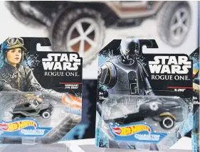  ??  ?? ABOVE AND BELOW Some of Mattel Inc’s Star Wars: Rogue One merchandis­e and The Force Awakens’ BB-8 droid toy.