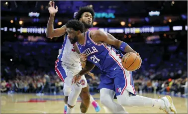  ?? MATT SLOCUM — THE ASSOCIATED PRESS ?? Joel Embiid, right, tries to get past Detroit’s Marvin Bagley III during the first half on Wednesday at the Wells Fargo Center.