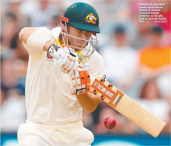  ?? Picture: GETTY ?? DIGGING IN: Australian opener David Warner playing an unusual rearguard innings yesterday as his side tried to savee the fourth Test.