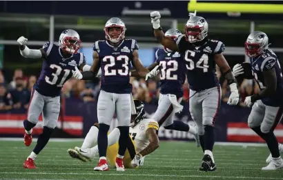  ?? NANCY LANE / HERALD STAFF FILE ?? THE BLUE GANG: The New England Patriots defense celebrates stopping the Steelers on fourth down during the second quarter of the season opener at Gillette Stadium.