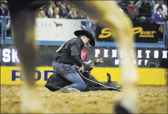  ?? Caroline Brehman Las Vegas Review-Journal ?? Trevor Brazile competes in tie-down roping during the final go-round of the NFR at the Thomas &amp; Mack Center on Saturday.