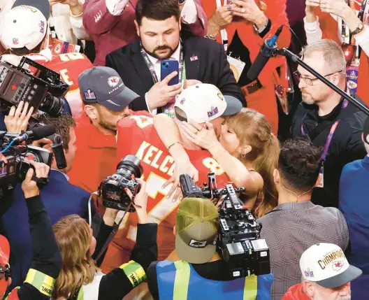  ?? TRIBUNE CONTENT AGENCY ?? Travis Kelce and Taylor Swift kiss after Kelce’s Kansas City Chiefs defeated the San Francisco 49ers to win Super Bowl LVIII last month in Houston.