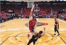  ?? AP Photo/Scott
Threlkeld ?? ■ New Orleans Pelicans forward Anthony Davis (23) goes to the basket over Portland Trail
Blazers guard Damian Lillard (0) during the second half of Game 4 of a first-round NBA playoff series Saturday in New
Orleans. The Pelicans won, 131123, to sweep...