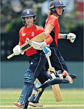  ??  ?? History maker: Tammy Beaumont (left) on her way to 1,000 T20 runs for England