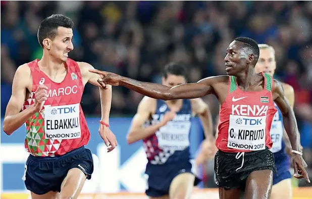  ?? AFP ?? Kenya’s Conseslus Kipruto (right) gestures to Morocco’s Soufiane Elbakkali as they race to the finish line in the final of the men’s 3,000m steeplecha­se event. —