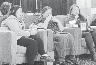  ?? ANDREW VAUGHAN THE CANADIAN PRESS ?? Kindra Bernard, right, with by her mother, Deana Beaton, left, holds a photo of her great-grandmothe­r at the Inquiry into Missing and Murdered Indigenous Women and Girls in Moncton, N.B. on Wednesday. Bernard's grandmothe­r Barbara Bernard, centre,...