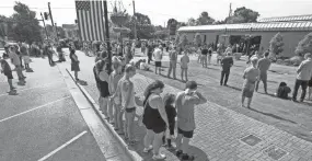  ?? MICKEY WELSH/HATTIESBUR­G ADVERTISER ?? People pray during a vigil in downtown Prattville, Ala., on June 5. They prayed for peace and justice.