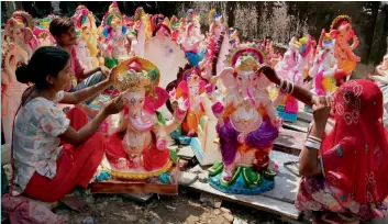  ?? — PTI ?? Artists give final touches to idols of Lord Ganesh ahead of Ganesh Chaturthi festival in Jammu on Wednesday.