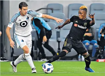  ??  ?? Rainbow warrior: Collin Martin dribbles past Latif Blessing in a Minnesota United match against Los Angeles FC in May, one month before Martin came out as gay
