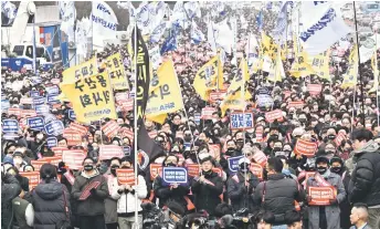  ?? — AFP file photo ?? Doctors shouting slogans with placards reading ‘Opposition to the increase in medical schools’ as they march during a rally to protest against the government’s plan to raise the annual enrolment quota at medical schools, in Seoul. South Korea’s government has offered its first concession to striking doctors in an effort to end a two-month-long walkout.