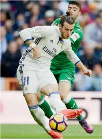  ?? AFP ?? Real Madrid’s forward Gareth Bale (left) vies with Leganes’s defender Diego Rico during the Spanish league match. —