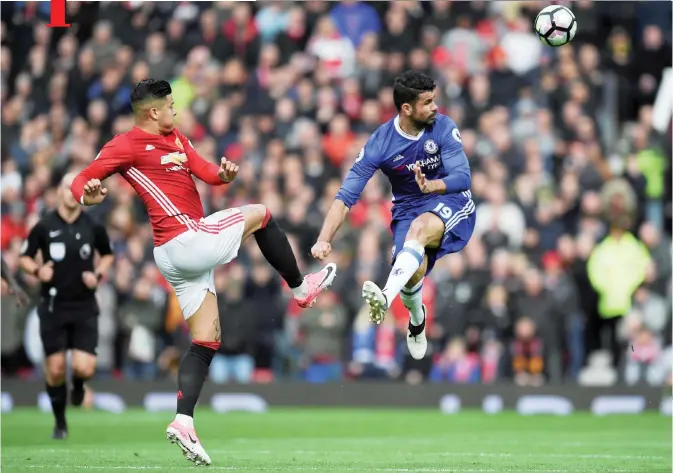  ??  ?? MANCHESTER: Manchester United’s Argentinia­n defender Marcos Rojo (L) vies with Chelsea’s Brazilian-born Spanish striker Diego Costa during the English Premier League football match between Manchester United and Chelsea at Old Trafford in Manchester, north west England, yesterday.— AFP