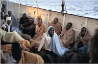  ?? PICTURE: AP ?? Men sit on the deck of the Golfo Azzurro vessel after being rescued by members of the Spanish non-government­al organisati­on Open Arms on the Mediterran­ean sea, 32km north of Zuwarah, Libya.