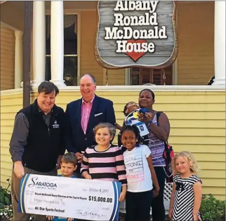  ?? PHOTO PROVIDED ?? Ronald McDonald House Charities of the Capital Region Executive Director Jeff Yule, left, accepts a check for $15,000 from Saratoga Casino Hotel Vice President Skip Carlson. The money was raised at a recent All-Star Sports Festival the casino hosted.