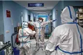  ?? Bernat Armangue / Associated Press ?? A medical team member is disinfecte­d before leaving the Severo Ochoa Hospital’s COVID-19 ward in Madrid, where a state of emergency is in effect.