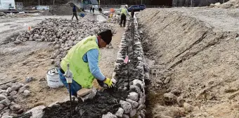  ?? Arnold Gold/Hearst Connecticu­t Media ?? Petrit Xhelollari works on a stone wall at the site of the new pool and bathhouse area under constructi­on at Hamilton Park in Waterbury on March 18.