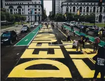  ?? RANDYVAZQU­EZ— STAFF PHOTOGRAPH­ER ?? Protesters paint a mural on the street outside of San Francisco City Hall on Monday. Most of the people involved in the demonstrat­ion were SEIU workers from local chapters showing support for the Black Lives Matter movement. The say Black and Latino workers aren’t on an equalwage playing field in many instances.