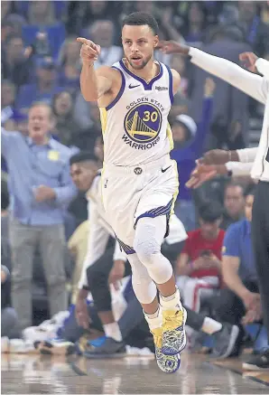  ??  ?? The Warriors’ Stephen Curry celebrates after scoring against the Thunder during the first half.