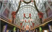  ?? DREAMSTIME ?? Christmas lights and decoration­s set a holly, jolly mood at O’Hare Internatio­nal Airport in Chicago.