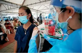  ?? AP ?? A health worker administer­s adoseofthe Sinovac Covid-19 vaccine to a resident of the Klong Toey area, a neighbourh­ood currently having a spike in coronaviru­s cases, in Bangkok.