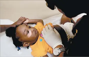  ?? CAROLYN COLE/LOS ANGELES TIMES ?? Kendra Curtis, 1, gets a check at the Capitol City Family Health Center in Baton Rouge, La. In Louisiana and 779 mostly rural counties, Medicaid and CHIP provide health coverage for many children in counties that voted for Donald Trump.