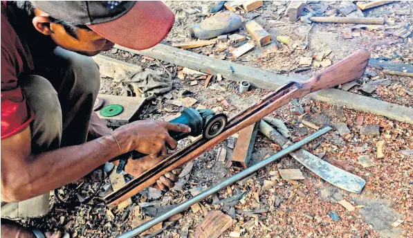  ??  ?? A member of the People’s Defence Force makes a gun near Demoso, in Kayah, top. Basic military training at an ethnic rebel group camp, left, and with the Karenni National Progressiv­e Party, right