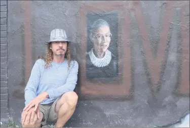  ?? MITCH HOTTS — THE MACOMB DAILY ?? Edward Stross shows his portrait of the late Supreme Court Justice Ruth Bader Ginsburg that he painted on the outdoor wall of his Gonzo Art Studio in Roseville.