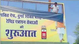  ?? HT ?? A worker of the public relations department removing a hoarding in front of the DC office in Sirsa on Saturday.