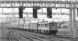  ?? Rob Newman/Creative Commons (geograph-2670053) ?? Motorail to Scotland continued into the BR sectorisat­ion period as part of InterCity and August 14, 1989 saw No. 87025 arrive at Crewe at the head of ‘The Clansman' from Euston to Inverness. The three GUVs behind the loco carry cars, this type of van being end loaded/unloaded via ramps at terminals.