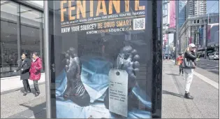  ?? CP PHOTO ?? An anti-fentanyl advertisme­nt is seen on a sidewalk in downtown Vancouver. New government figures show that nearly 4,000 Canadians died from apparent opioid overdoses last year, with men the most likely victims and fentanyl the clear culprit.