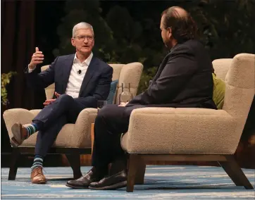 ?? ANDA CHU — STAFF PHOTOGRAPH­ER ?? Apple CEO Tim Cook, left, and Salesforce CEO Marc Benioff speak Tuesday at “Dreamforce,” Salesforce’s conference at the Moscone Center in San Francisco.